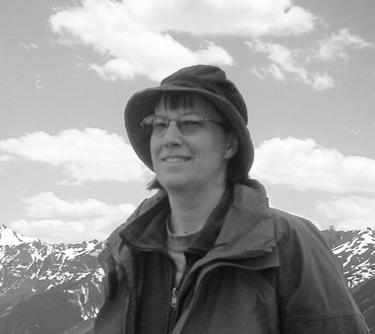 Black and white image of an astronomer in New Mexico. Those of you with keen eyes and a good knowledge of New Mexican geography may notice an unexpected telescope dome on the mountains in the background.