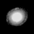 Black and white spiral galaxy image at red      wavelengths, showing spiral arms and a bright central bulge.