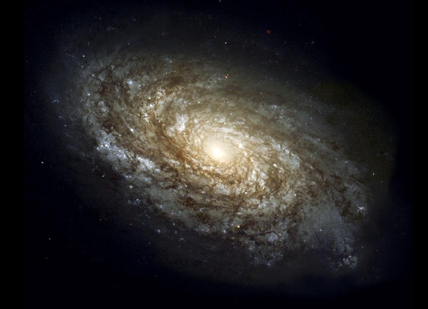 A spiral galaxy like our own Milky Way, with a bright yellowish central bulge surrounded by white and bluish spiral arms.