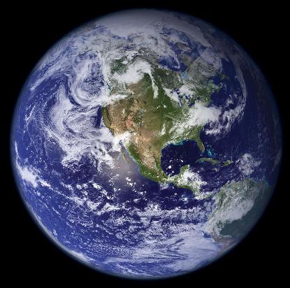 Planet Earth viewed from space, showing blue oceans, green and brown continents, and cloud structures in the atmosphere above.