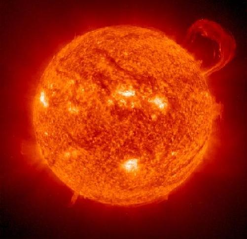 The Sun, a giant ball of red and yellow gas, with hot spots and protuberances on its surface.