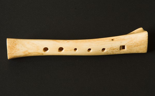 Recorder (woodwind instrument like a flute) made out of an animal bone which has been hollowed out, with holes added to be left open or closed with the fingers.