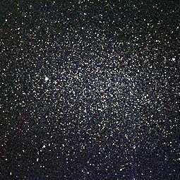 Telescope image of elliptical galaxy Leo I, a dwarf galaxy near to the Milky Way. The image shows a panorama of stars, with an overdensity of them in the center.