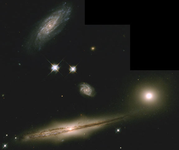 Image of the HCG 87 group of galaxies, showing several inclined spiral galaxies, one with prominent dust lanes. Though not massive enough to qualify as a cluster, this set of galaxies is gravitationally bound together.