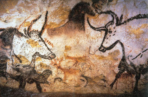 Prehistoric painting of aurochs, horses, and deer in rich brown, white, and black shades from the Lascaux Cave in France.