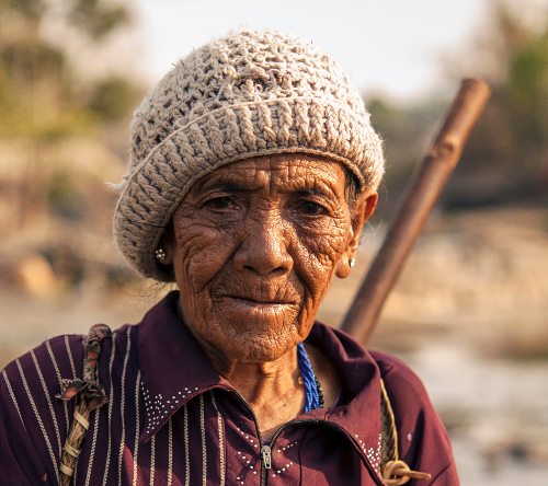 An elderly person with a face lined with a lifetime of experiences.