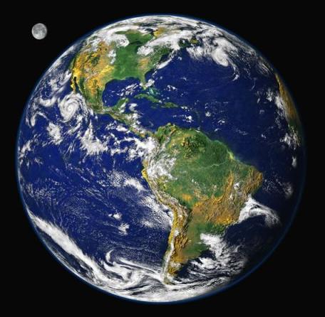 Planet Earth, with vivid green and yellow continents, deep blue oceans, and streaky white clouds above. The Moon is shown in the background.