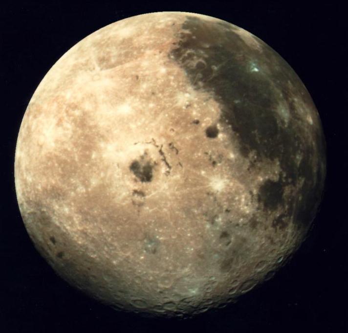 The Earth's natural satellite Luna (the Moon), with a heavily cratered stark brown and yellow surface.