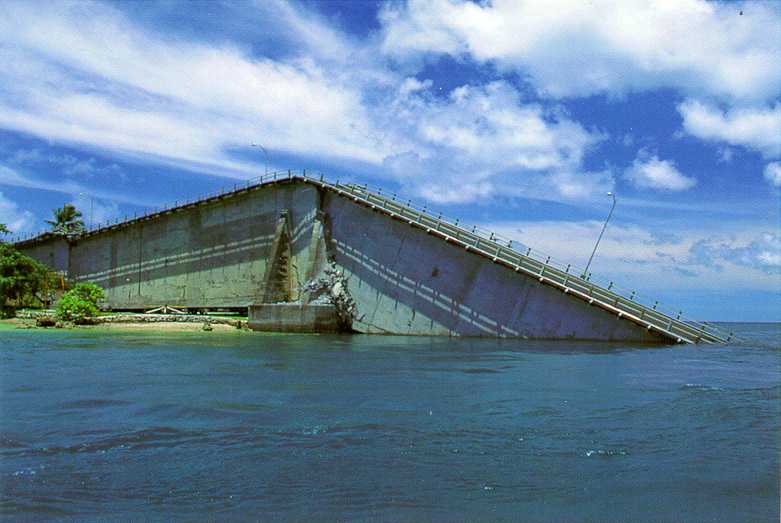 Palau bridge after collapse, showing concrete segment which has toppled into the water.