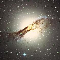 Telescope image of elliptical galaxy NGC 5128, a peculiar galaxy with a golden halo of stars but also clear dark dust lanes. The center of this galaxy hosts a supermassive black hole.