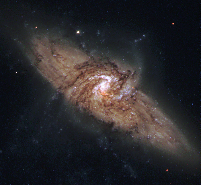 Be careful with this image - rather than interacting galaxies, we have here two galaxies which by chance align along a single line of sight when viewed from Earth! Because the foreground galaxy is viewed face-on, this gives us a wonderful opportunity to examine the spiral arm patterns in its disk which surround the bright nucleus.