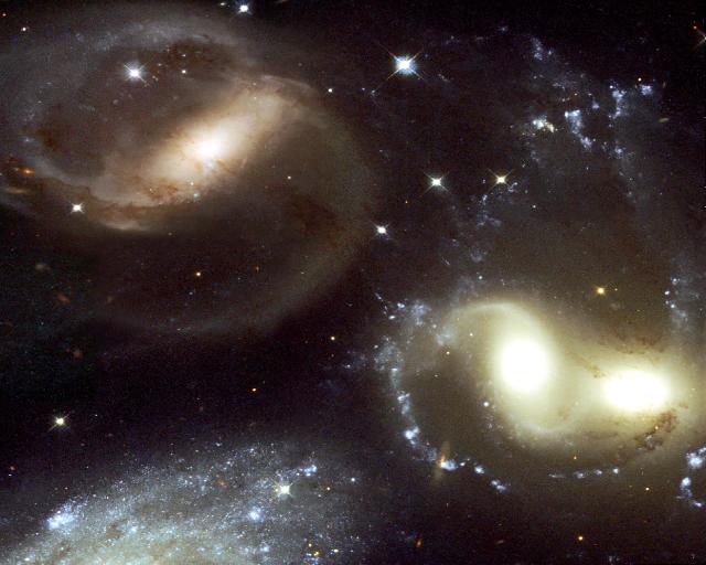Gorgeous group of interacting galaxies of all colors and shapes, showing clear disorder.