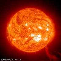 Bright red, orange, and yellow image of the Sun, showing huge plumes streamin goff of the surface